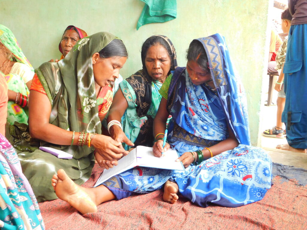 Netris in Maharashtra attending a village meeting and marking their attendance for it 
